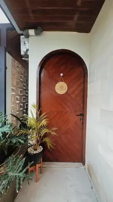 a wooden door with a welcome sign on it at Batara Room in Nusa Dua