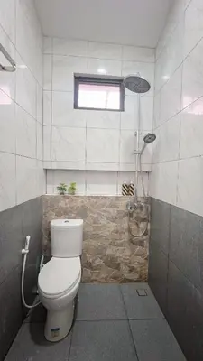 a bathroom with a toilet and a shower at Batara Room in Nusa Dua
