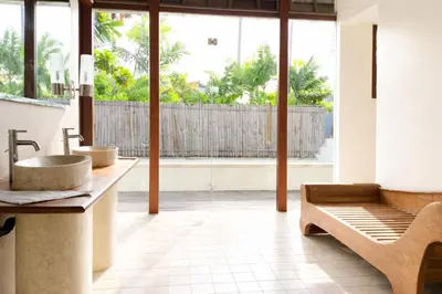 a bathroom with two sinks and a large window at Calladi Villa in Seminyak