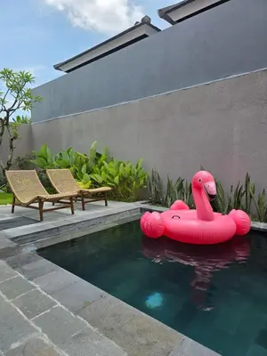 a pool with an inflatable flamingo in the water at Le Calme Villa Brand New 2 BR Private Villa near Seminyak in Kerobokan