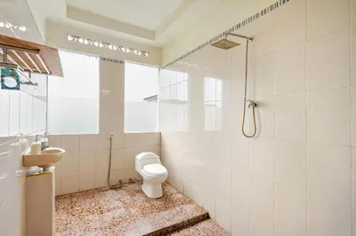 a bathroom with a toilet and a shower at Dbelid Royal House - Private 5BR Villa in Jimbaran in Jimbaran