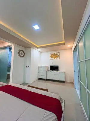 a bedroom with a bed and a tv in it at Dbelid Royal House - Private 5BR Villa in Jimbaran in Jimbaran