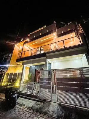 a building with a balcony on top of it at night at Dbelid Royal House - Private 5BR Villa in Jimbaran in Jimbaran