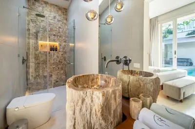 a bathroom with two wooden stump tubs at Magic Day 2BR Private Sauna, Jacuzzi, Projector in Seminyak