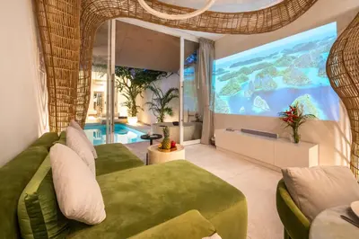 a living room with a large projection of the ocean at Magic Day 2BR Private Sauna, Jacuzzi, Projector in Seminyak