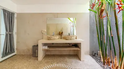 a bathroom with a sink and a mirror at Villa Alana, 3 BR Villa in Kerobokan in Mantaak