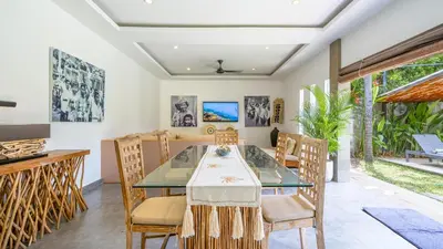 a dining room with a table and chairs at Villa Alana, 3 BR Villa in Kerobokan in Mantaak