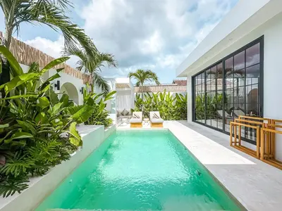 an infinity pool in the backyard of a villa at Villa Nabu - Serene Tropical Escape in Heart of Seminyak in Seminyak