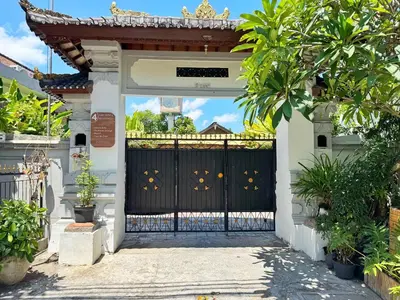 a black gate in a house with plants at Private Room, 2 Minutes walk to KuDeTa Beach Seminyak in Seminyak