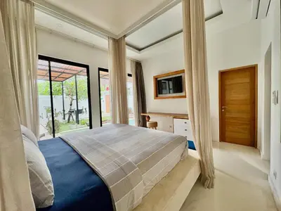 a bedroom with a large bed and a window at Casa Bali in Kerobokan
