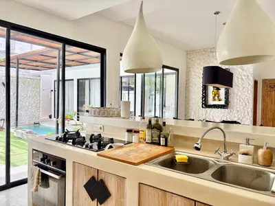 a kitchen with a sink and a stove at Casa Bali in Kerobokan