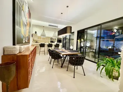 a kitchen and dining room with a table and chairs at Casa Bali in Kerobokan