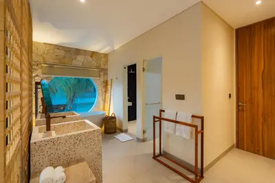 a bathroom with a sink and a mirror at Villa Twin 1 by BaliSuperHost in Seminyak