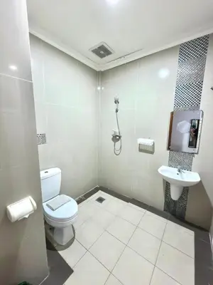 a bathroom with a toilet and a sink at Famora Stay Kuta Bali in Ngurah Rai International Airport