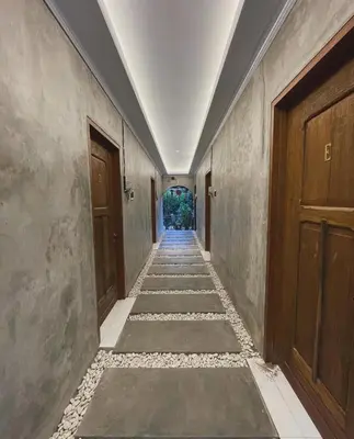 an empty corridor of a building with wooden doors at ET Living Cozy Studio Room in Kerobokan