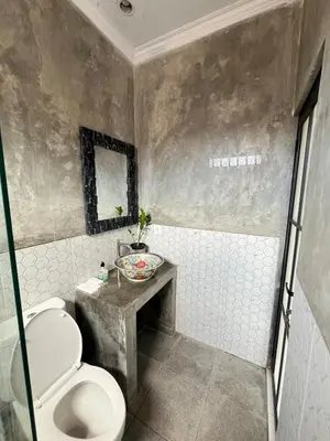 a bathroom with a toilet and a sink at ET Living Cozy Studio Room in Kerobokan