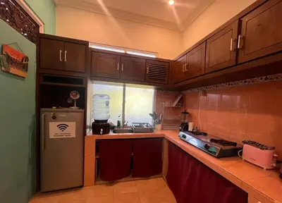 a kitchen with wooden cabinets and a refrigerator at Digital Nomad Oasis in Bali Calm, Cozy, Connected in Kerobokan