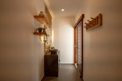 a hallway with a door leading to a bathroom with a sink at A Better Villa 3BR Seminyak 5min Beach Bintang in Seminyak