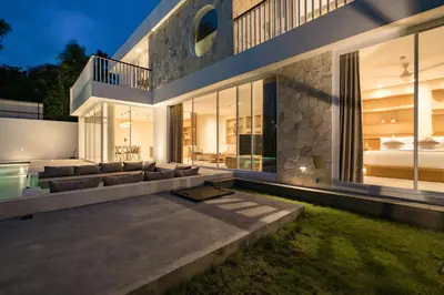 a large house with a couch and a bed at Villa Tiga by BaliSuperHost in Canggu