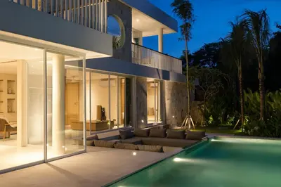 an exterior view of a house with a swimming pool at Villa Tiga by BaliSuperHost in Canggu