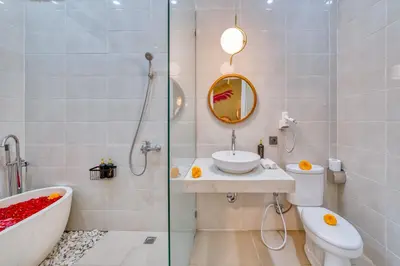 a bathroom with a toilet and a sink and a bath tub at Affordable 2 Bedroom Villa in Kerobokan with Private Pool in Kerobokan