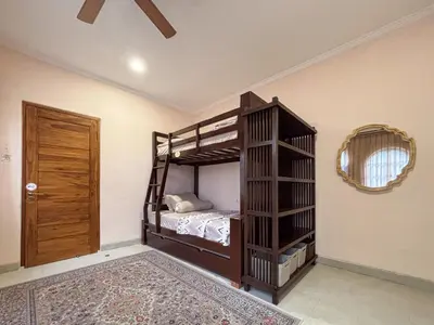 a bedroom with a bunk bed and a mirror at The Lavana Villa Bungas near Nusa Dua in Jimbaran
