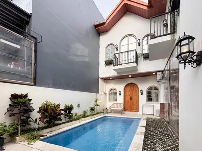 a house with a swimming pool next to a building at The Lavana Villa Bungas near Nusa Dua in Jimbaran