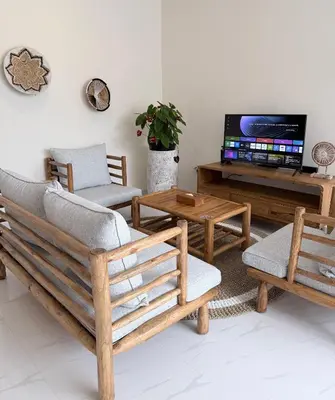 a living room with wooden furniture and a flat screen tv at Villa Amore in Canggu