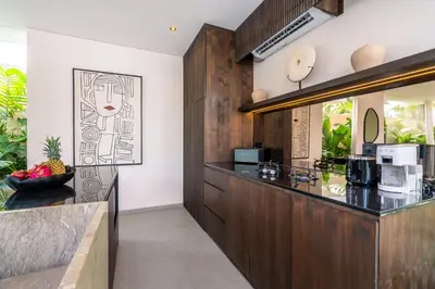 a kitchen with wood paneling and a counter at Villa Knack, Seminyak in Kerobokan
