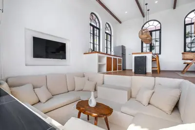 a living room with a white couch and a table at Palm Sugar Villa - Stylish 3BR Retreat with Pool in Jimbaran