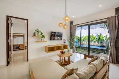 a living room with a couch and a table at Ondio Villa in Seminyak