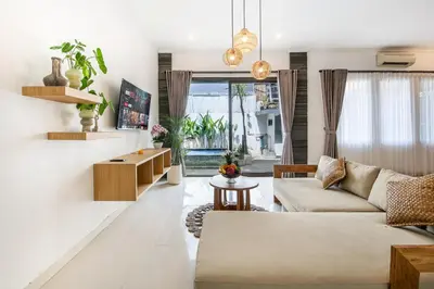 a living room with a couch and a table at Ondio Villa in Seminyak