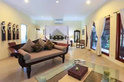 a living room with a couch and a fireplace at Indira Peaceful 1 BR Private Pool Villa in Seminyak