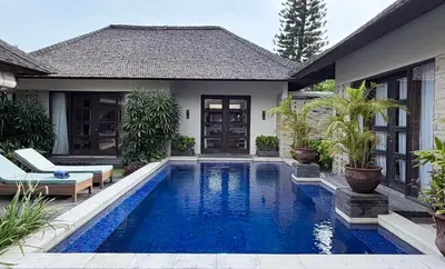a swimming pool in the backyard of a house at Alex Villa Bali in Seminyak