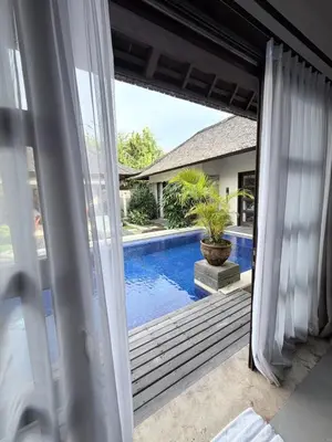 a view of a swimming pool through a sliding glass door at Alex Villa Bali in Seminyak