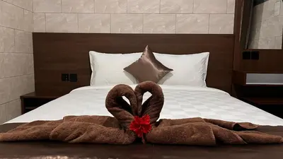 a bed with two towels on top of it at Tirta Suci Guest House in Ngurah Rai International Airport