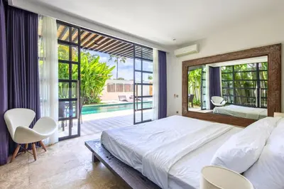 a bedroom with a large bed and a large window at Zen Retreat 3BR Japanese Inspired Oasis with Pool in Canggu