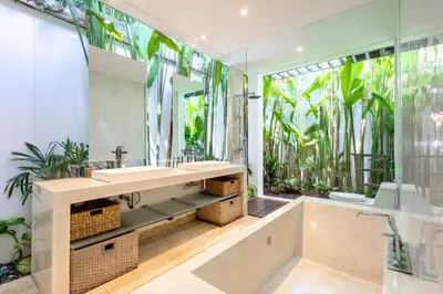 a bathroom with a tub and a sink and a mirror at Zen Retreat 3BR Japanese Inspired Oasis with Pool in Canggu