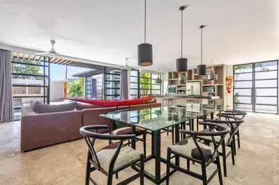 a kitchen and living room with a glass table and chairs at Zen Retreat 3BR Japanese Inspired Oasis with Pool in Canggu