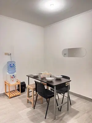 a dining room with a black table and chairs at Cozy Minimalist Home Near Seminyak & Kuta in Seminyak