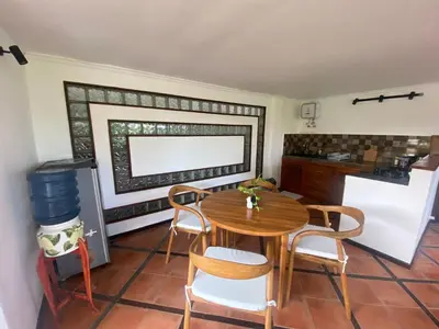 a kitchen with a table and chairs in a room at arjuna house in Seminyak