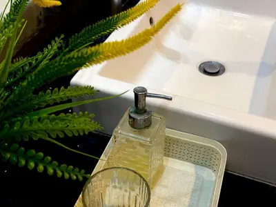 a bottle of soap sitting on a sink at Jalina Private Villa in Central Seminyak in Seminyak