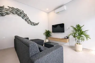 a living room with a couch and a tv at Brand new central Villa in Canggu