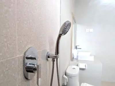 a shower head in a bathroom with a toilet at Brand new central Villa in Canggu