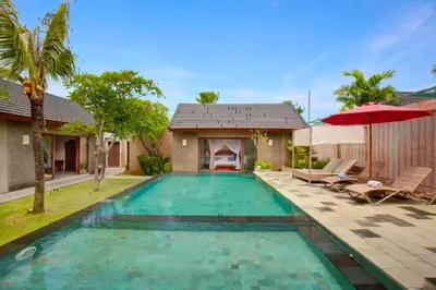 a swimming pool in the backyard of a villa at Eksha Comfortable 3 BR Private Pool Villa in Jimbaran