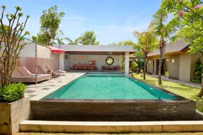 a swimming pool in the backyard of a house at Eksha Comfortable 3 BR Private Pool Villa in Jimbaran
