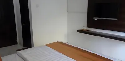 a bedroom with a bed and a flat screen tv at Wisp Sunset in Legian