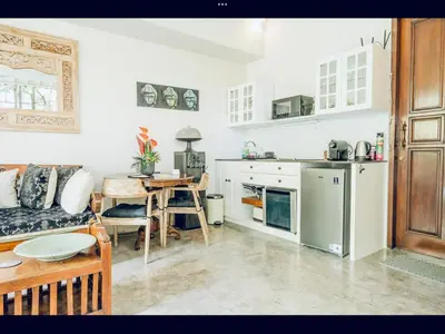 a kitchen with a couch and a table in a room at Romantic getaway Seminyak in Seminyak