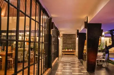 a hallway of a building with large glass windows at Ghania Peaceful 3 BR Private Pool Villa in Jimbaran