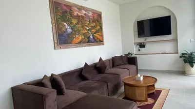 a living room with a couch and a table at Narayuka private villa in Seminyak